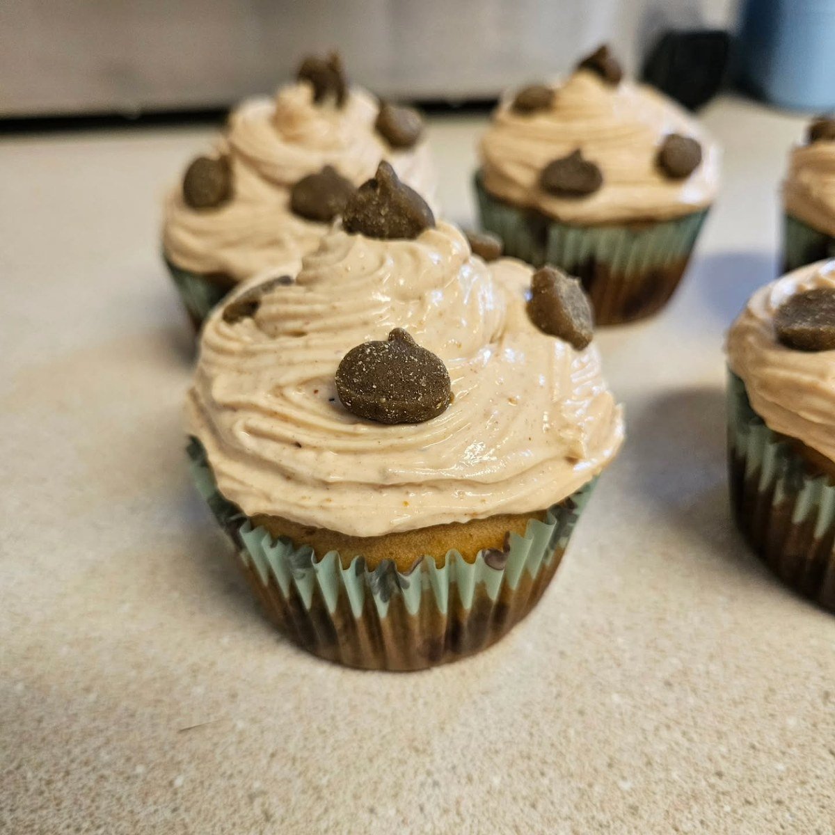 Banana pupcakes with swirled peanut butter Greek yogurt frosting topped with dog treats