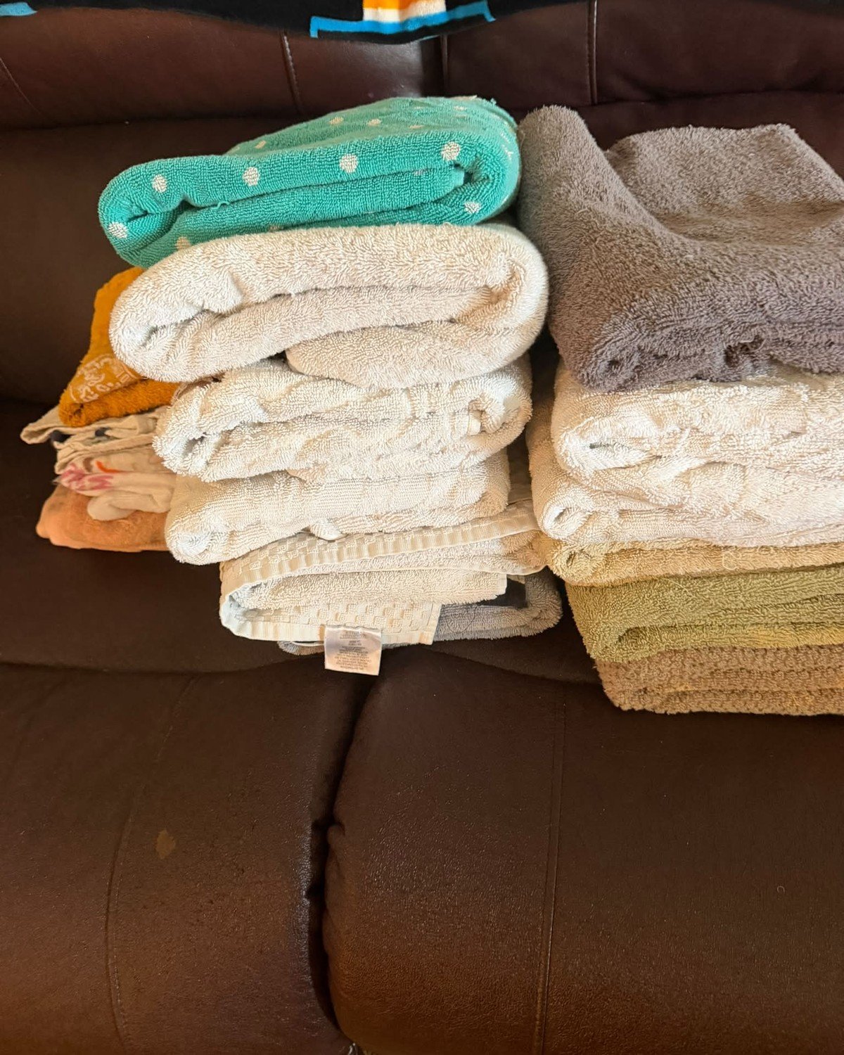 Folded towels being donated to an animal shelter