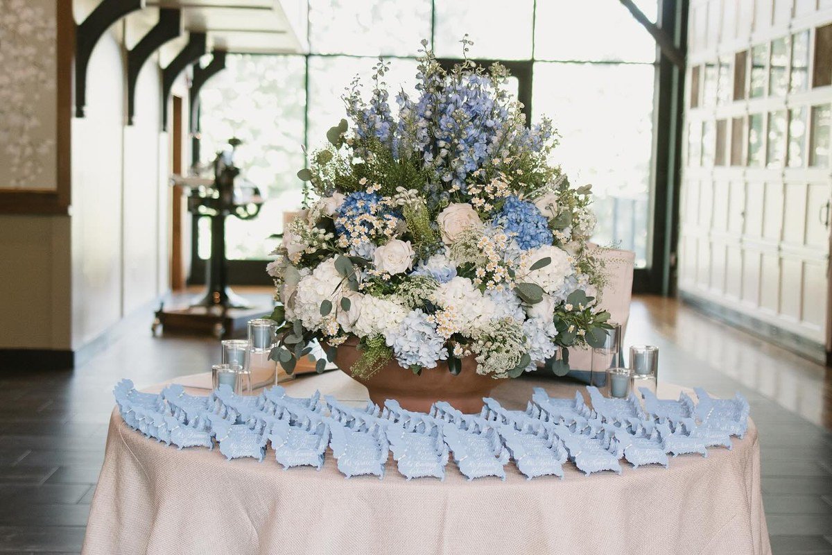 Escort card table with light-blue dog-shaped illustrated escort cards