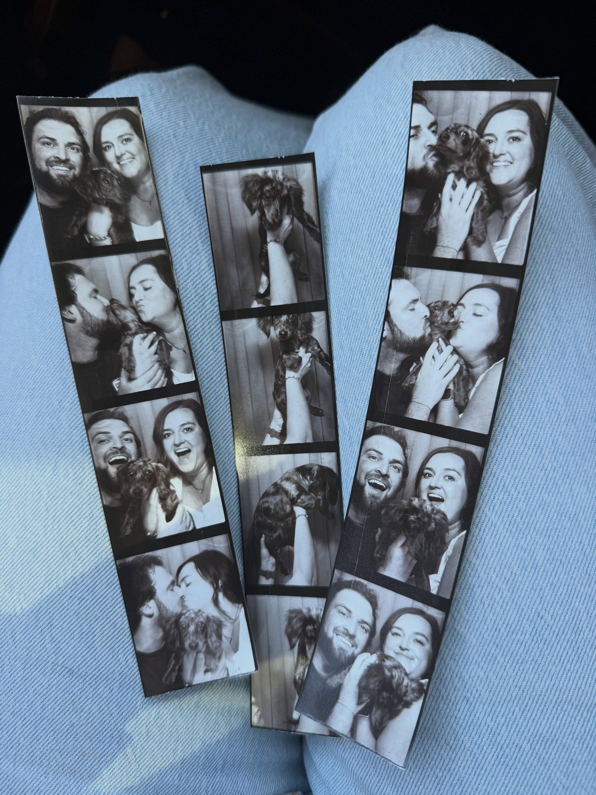 Three black-and-white photo booth strips show a couple posing with their small dachshund puppy.