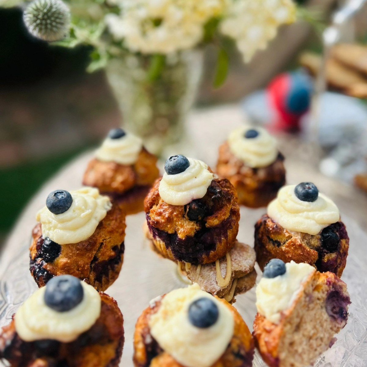 Blueberry pupcakes with piped mashed-potato frosting swirls topped with blueberries
